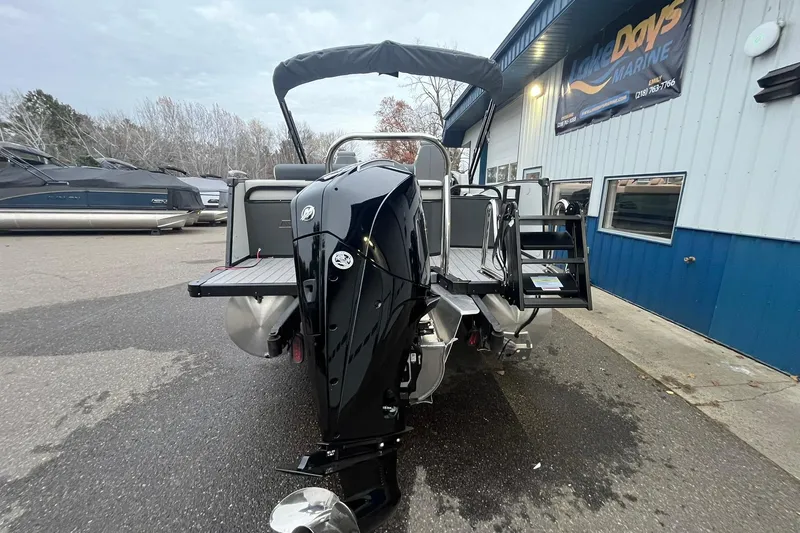 Slide: The Image of 2026 Avalon Catalina Versatile Rear Lounger boat at marina, rear view with motor. - 3