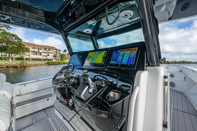 Slide: The Image of 2023 HCB 53 Sueños boat cockpit with advanced navigation displays and luxurious seating. - 14