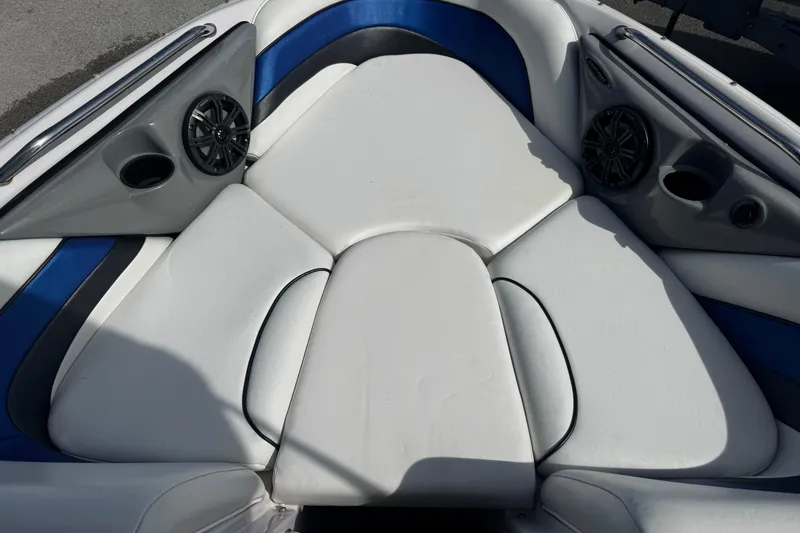 Slide: The Image of 2004 Nautique Air Nautique 216 boat interior with white and blue seating. - 12