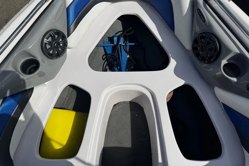 Slide: The Image of 2004 Nautique Air Nautique 216 boat interior with speakers and storage compartments. - 13