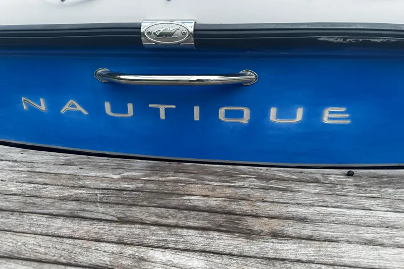 Slide: The Image of 2004 Nautique Air Nautique 216 boat, blue hull with chrome lettering and handle. - 18