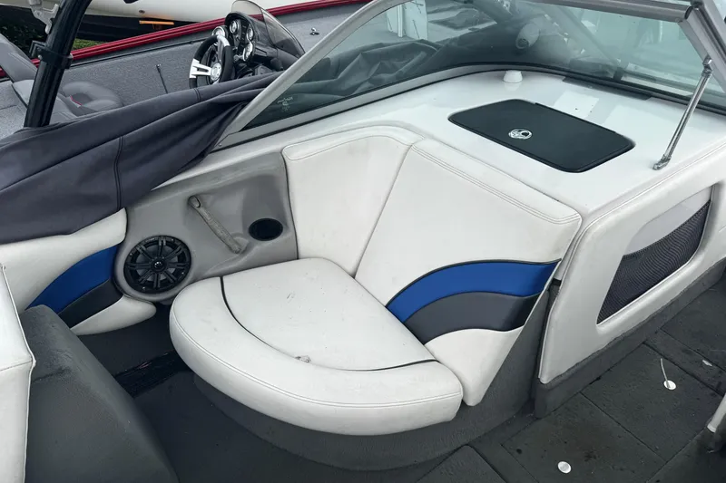 Slide: The Image of 2004 Nautique Air Nautique 216 boat interior with white and blue seating. - 9