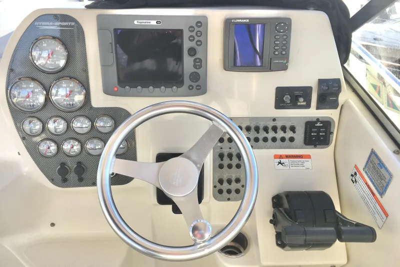 Slide: The Image of 2006 Hydra-Sports Vector 2900 VX dashboard with gauges, steering wheel, and navigation equipment. - 11