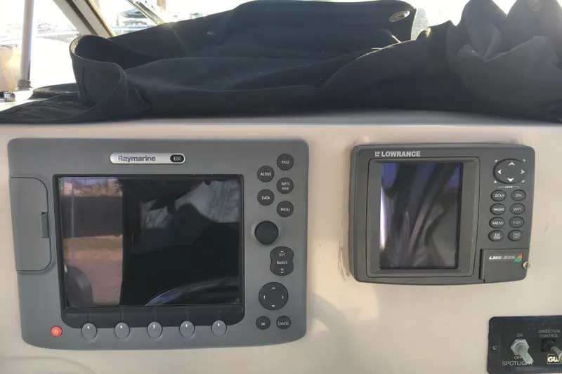 Slide: The Image of 2006 Hydra-Sports Vector 2900 VX dashboard with Raymarine and Lowrance navigation systems. - 13