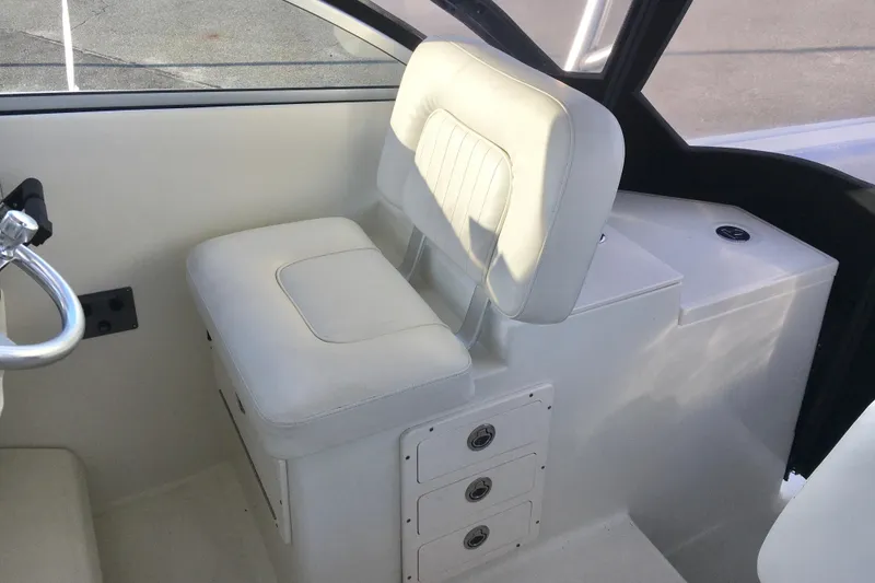 Slide: The Image of 2006 Hydra-Sports Vector 2900 VX interior with white cushioned seating and storage compartments. - 15