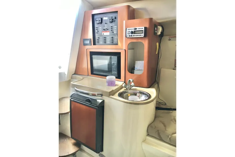 Slide: The Image of 2006 Hydra-Sports Vector 2900 VX cabin with kitchenette, microwave, sink, and control panel. - 33