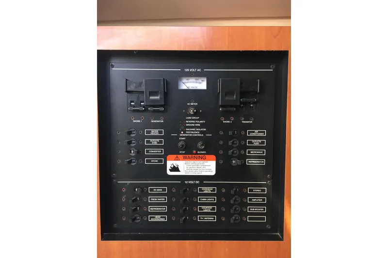 Slide: The Image of Electrical panel of 2006 Hydra-Sports Vector 2900 VX boat with various switches and warning label. - 34