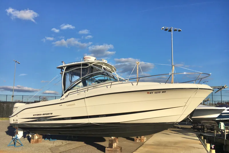 Slide: The Image of 2006 Hydra-Sports Vector 2900 VX boat on stands under a clear blue sky. - 4