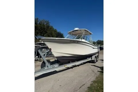 The Image of 2011 Grady-White Freedom 275 boat on trailer under clear blue sky. - 0