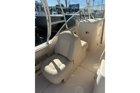 Slide: The Image of 2011 Grady-White Freedom 275 boat interior with beige seating and helm. - 10
