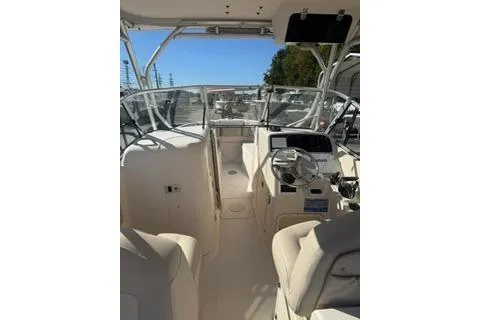 Slide: The Image of 2011 Grady-White Freedom 275 boat interior with steering wheel and seating. - 12