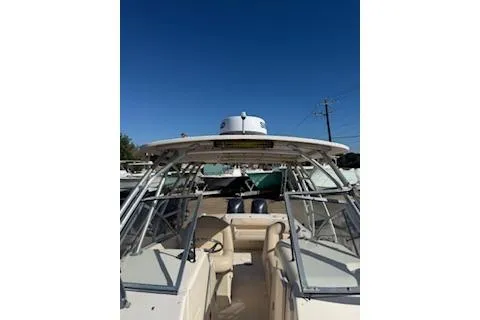 Slide: The Image of 2011 Grady-White Freedom 275 boat with open cockpit and clear blue sky. - 17