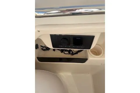 Slide: The Image of 2011 Grady-White Freedom 275 boat console with storage compartment and cup holder. - 20