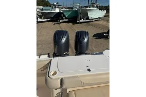 Slide: The Image of 2011 Grady-White Freedom 275 boat with dual outboard motors, docked on a sunny day. - 5