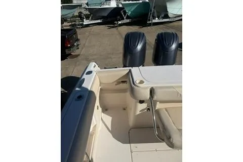 Slide: The Image of 2011 Grady-White Freedom 275 boat with dual outboard motors, docked on a sunny day. - 8