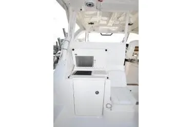 Slide: The Image of 2021 Pursuit OS 355 Offshore boat interior with sleek white cabinetry and seating. - 11
