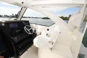 Slide: The Image of 2021 Pursuit OS 355 Offshore boat interior with steering wheel and control panel. - 14
