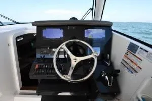Slide: The Image of 2021 Pursuit OS 355 Offshore helm with modern navigation displays and steering wheel. - 15