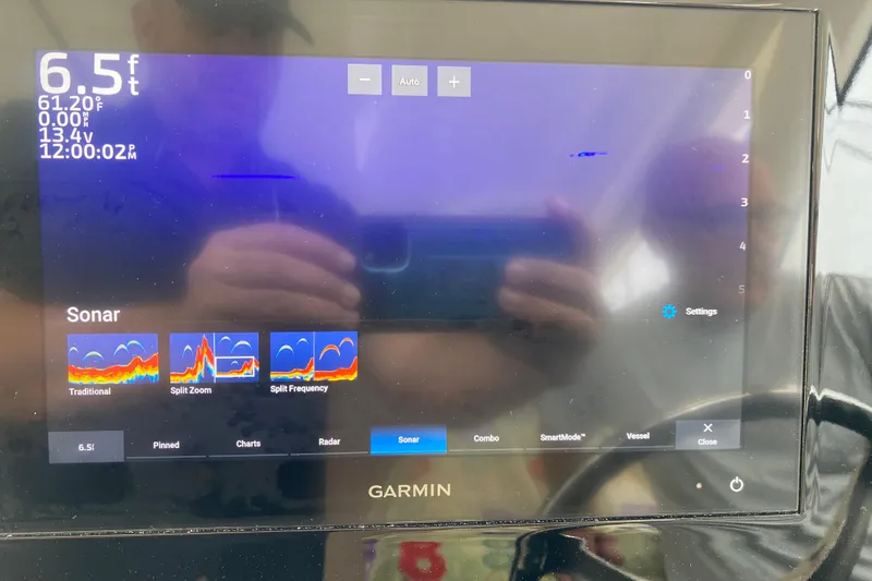 Slide: The Image of Garmin sonar display on 2021 Pursuit OS 355 Offshore boat, showing depth and settings. - 17