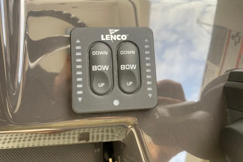 Slide: The Image of Lenco trim tab control on 2021 Pursuit OS 355 Offshore boat dashboard. - 23
