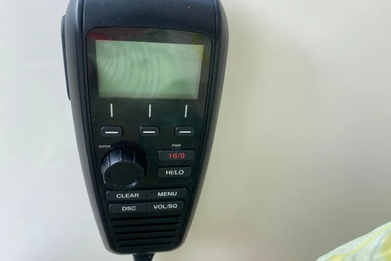 Slide: The Image of Close-up of a marine radio on a 2021 Pursuit OS 355 Offshore boat. - 24
