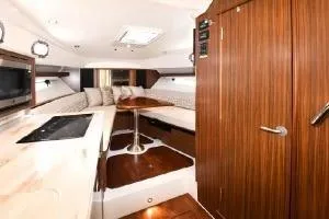 Slide: The Image of 2021 Pursuit OS 355 Offshore cabin interior with wood finish and modern amenities. - 30