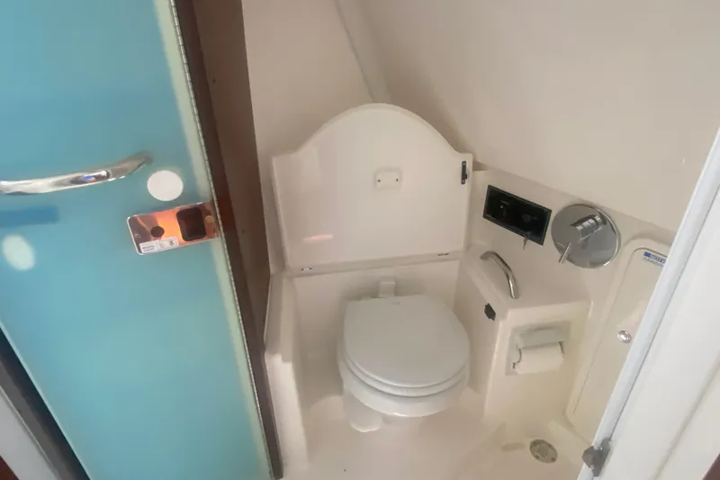 Slide: The Image of 2021 Pursuit OS 355 Offshore boat bathroom with toilet and modern fixtures. - 33