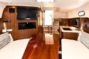 Slide: The Image of Luxurious interior of 2021 Pursuit OS 355 Offshore boat with wood finishes and modern amenities. - 34