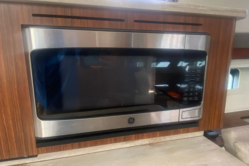 Slide: The Image of Built-in microwave in 2021 Pursuit OS 355 Offshore boat kitchen. - 38