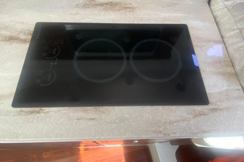 Slide: The Image of Glass cooktop on a 2021 Pursuit OS 355 Offshore boat's countertop. - 39
