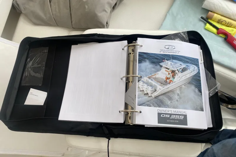 Slide: The Image of Owner's manual for 2021 Pursuit OS 355 Offshore boat in a black binder. - 40