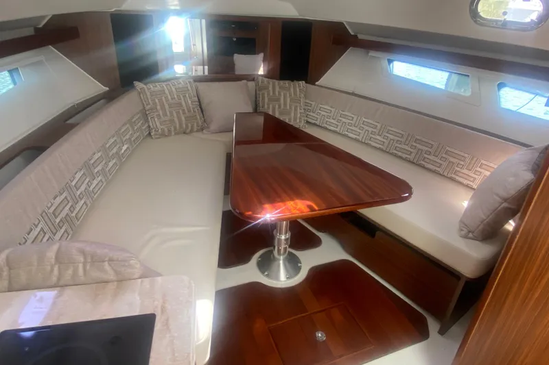 Slide: The Image of Luxurious interior of 2021 Pursuit OS 355 Offshore yacht with elegant seating and wooden table. - 43