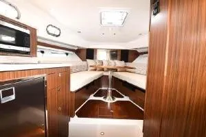 Slide: The Image of 2021 Pursuit OS 355 Offshore cabin interior with wood finish and modern amenities. - 45