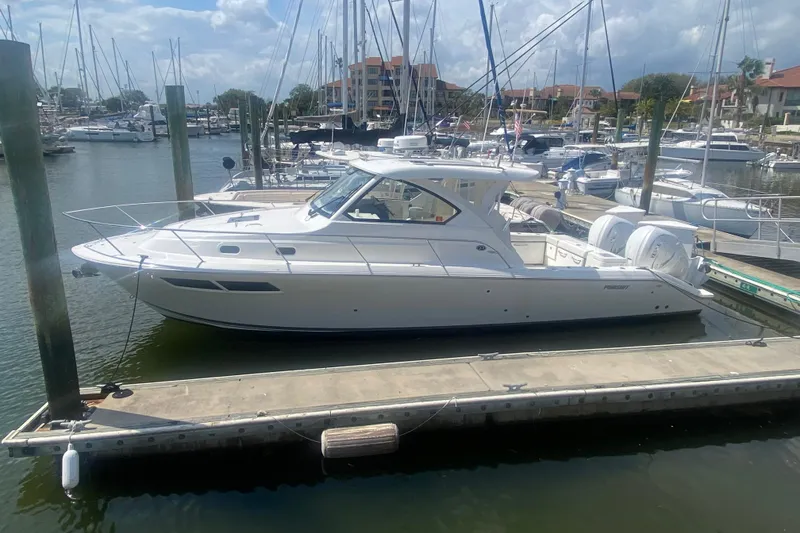 Slide: The Image of 2021 Pursuit OS 355 Offshore boat docked in a marina with other vessels. - 51
