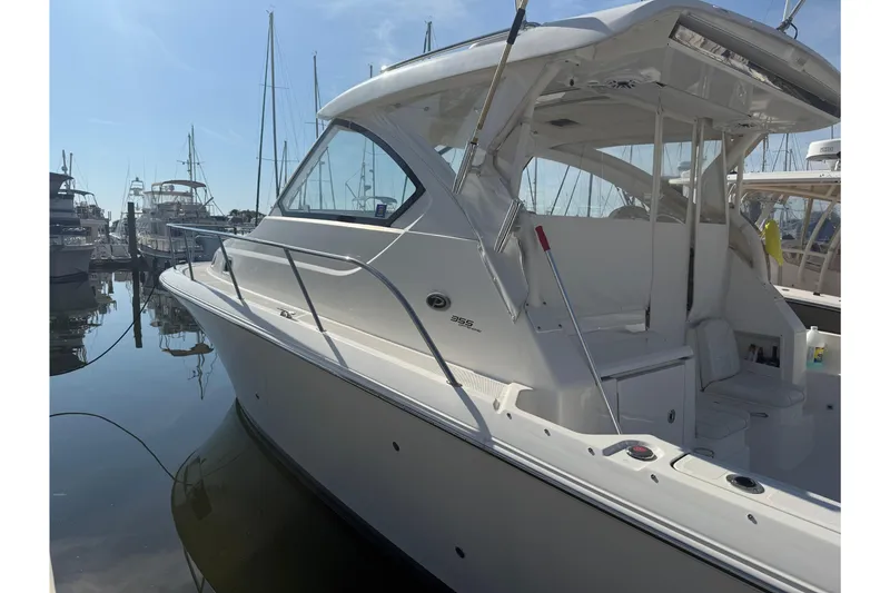Slide: The Image of 2021 Pursuit OS 355 Offshore boat docked at marina under clear blue sky. - 53