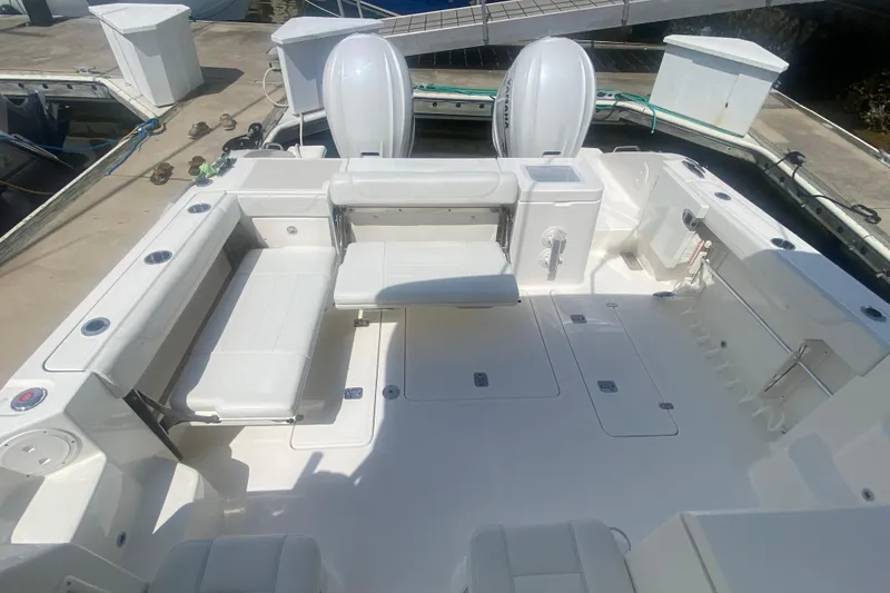 Slide: The Image of 2021 Pursuit OS 355 Offshore boat deck with seating and storage compartments. - 7