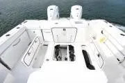 Slide: The Image of 2021 Pursuit OS 355 Offshore boat deck with storage compartments and twin engines. - 8