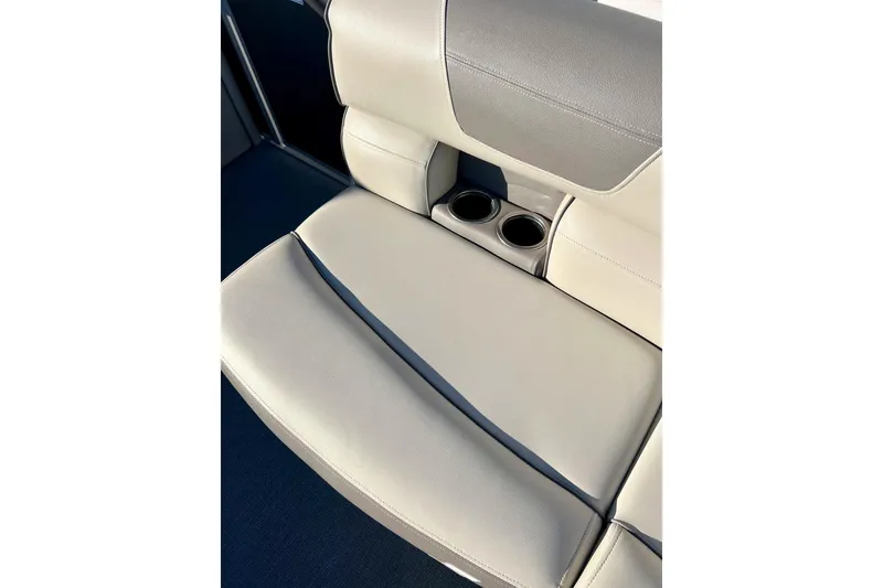 Slide: The Image of 2021 SMOKERCRAFT EX20C boat interior with storage compartment and cup holders. - 18