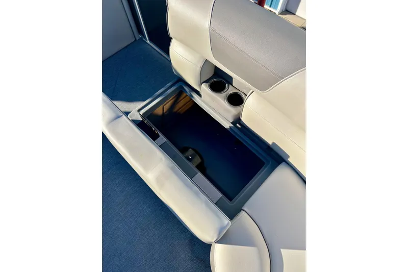 Slide: The Image of 2021 SMOKERCRAFT EX20C boat seat with cup holders, featuring gray and white upholstery. - 19