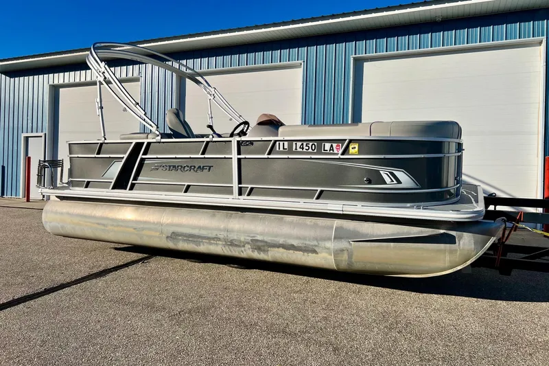 Slide: The Image of 2021 SMOKERCRAFT EX20C boat with Starcraft branding, close-up view. - 2