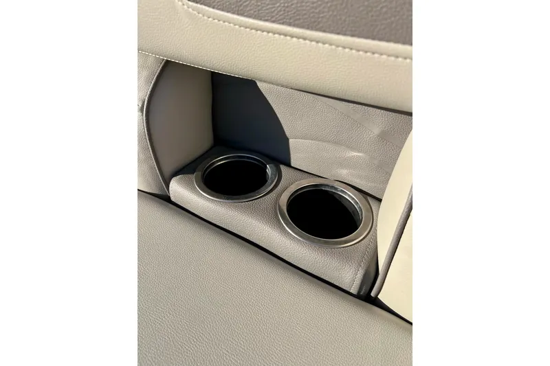 Slide: The Image of 2021 SMOKERCRAFT EX20C boat console with storage compartment and steering wheel. - 26