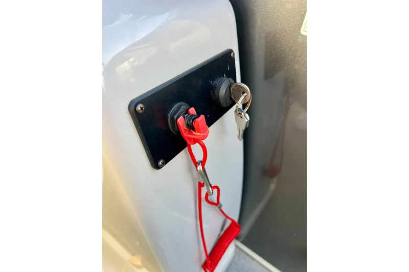 Slide: The Image of 2021 SMOKERCRAFT EX20C boat seat, light gray upholstery, armrests, outdoor setting. - 38