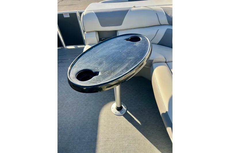 Slide: The Image of 2021 SMOKERCRAFT EX20C boat interior with storage compartment and cup holders. - 40