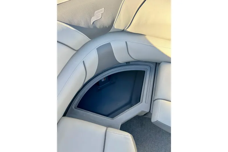 Slide: The Image of 2021 SMOKERCRAFT EX20C boat interior with gray cushioned seating and cup holders. - 44