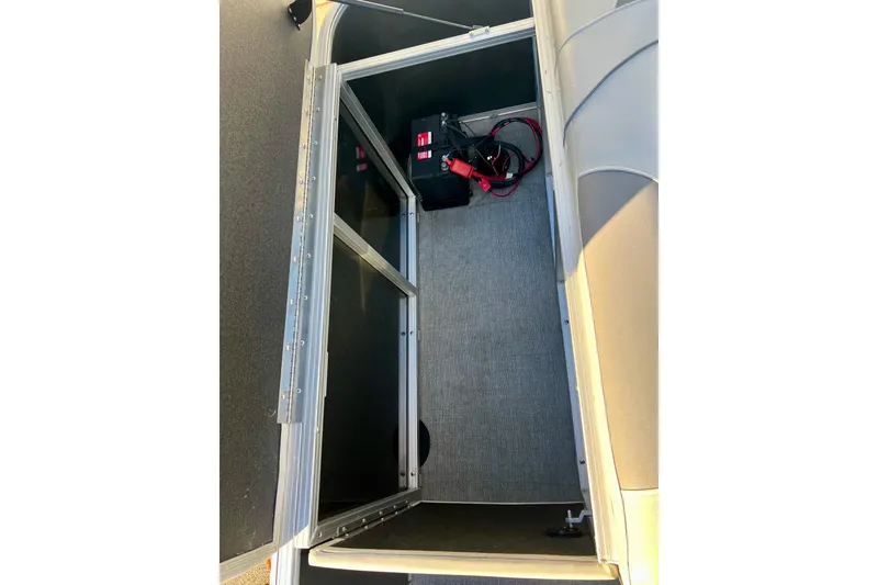 Slide: The Image of 2021 SMOKERCRAFT EX20C pontoon boat interior with seating and carpeted floor. - 49