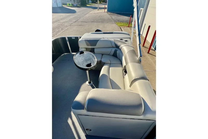 Slide: The Image of 2021 SMOKERCRAFT EX20C boat interior with gray seating and cup holders. - 57