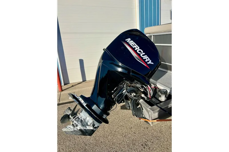 Slide: The Image of 2021 SMOKERCRAFT EX20C boat with stainless steel ladder and dockside view. - 8