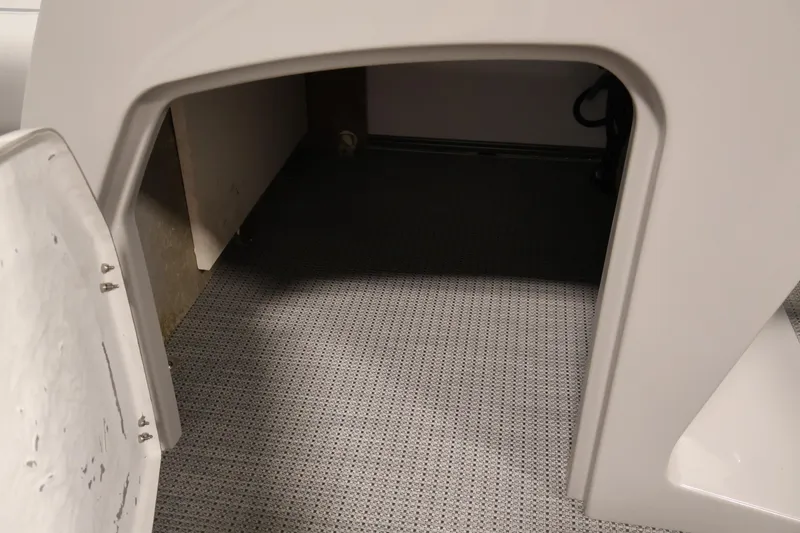 Slide: The Image of Storage compartment in 2026 Bentley Pontoons 220 SWINGBACK, featuring carpeted interior. - 17