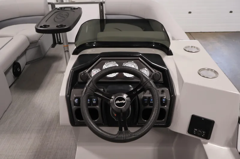 Slide: The Image of 2026 Bentley Pontoons 220 SWINGBACK dashboard with steering wheel and control panel. - 18
