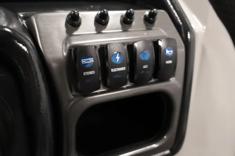 Slide: The Image of Control panel of 2026 Bentley Pontoons 220 SWINGBACK with labeled switches for stereo and electronics. - 22